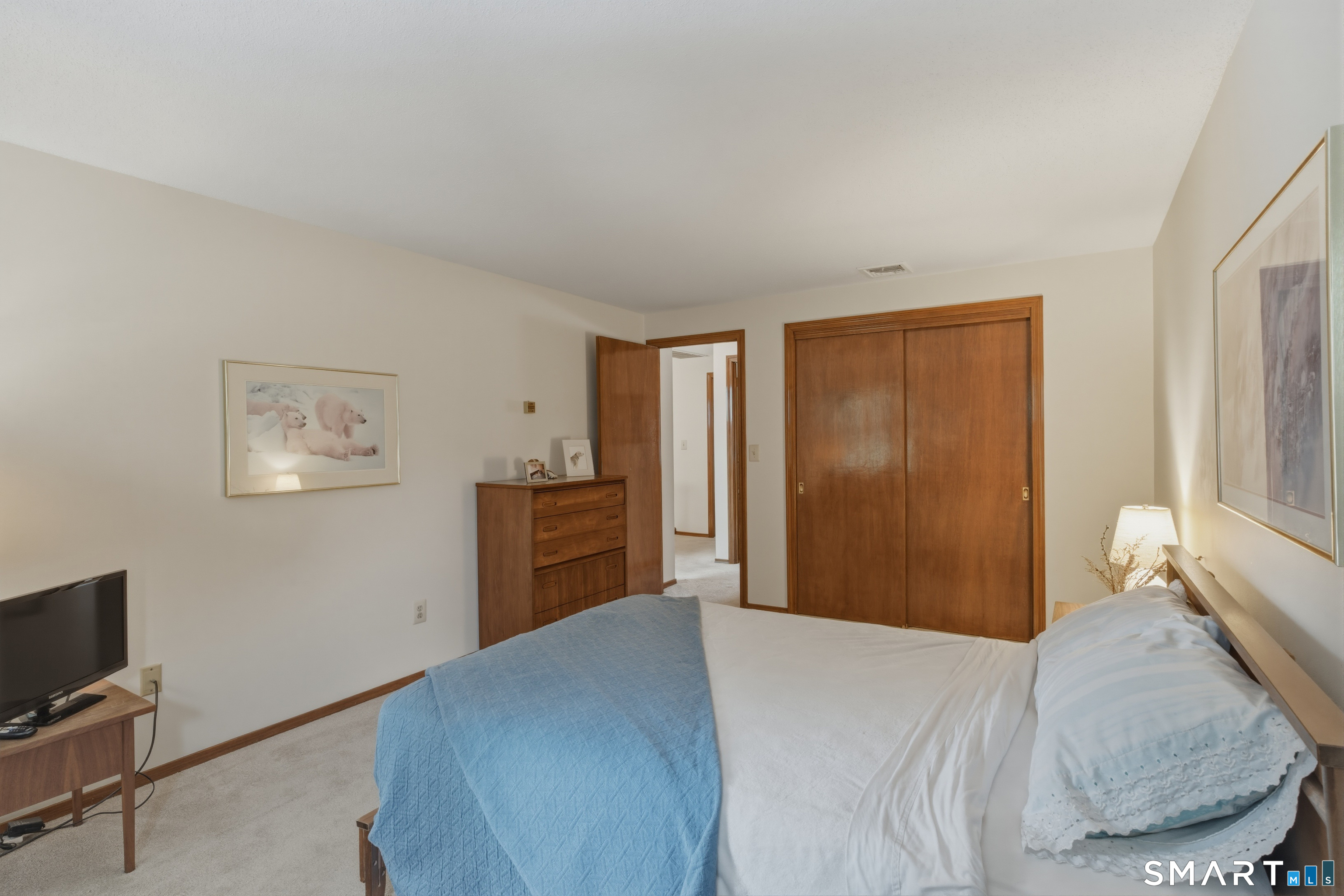 15 Potter Crossing, Unit 15 Wethersfield, CT 06109 - Photo 14 of 21 a bedroom with a bed and a flat screen tv
