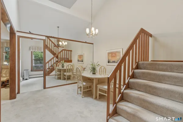 a dining room with furniture and a floor to ceiling window