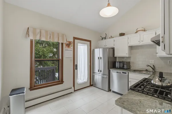 a kitchen with cabinets a refrigerator and a sink