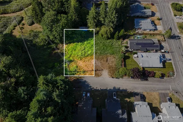 an aerial view of a houses with yard