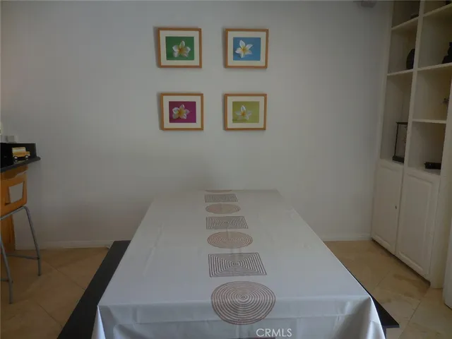 a view of a hallway with wooden cabinets and a bathroom