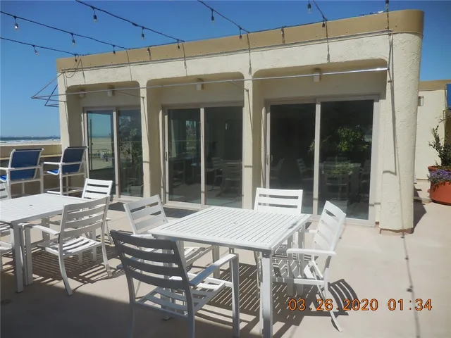 a view of a patio with table and chairs and potted plants
