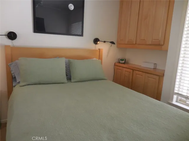 a bed room with a bed and a lamp