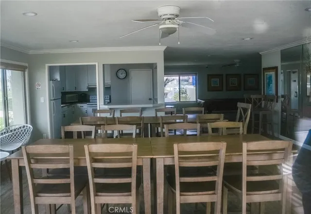 a kitchen with a table chairs stove and cabinets