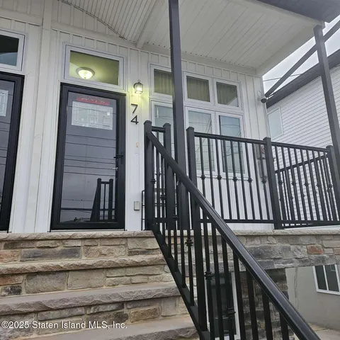 a view of a hallway with wooden floor and furniture