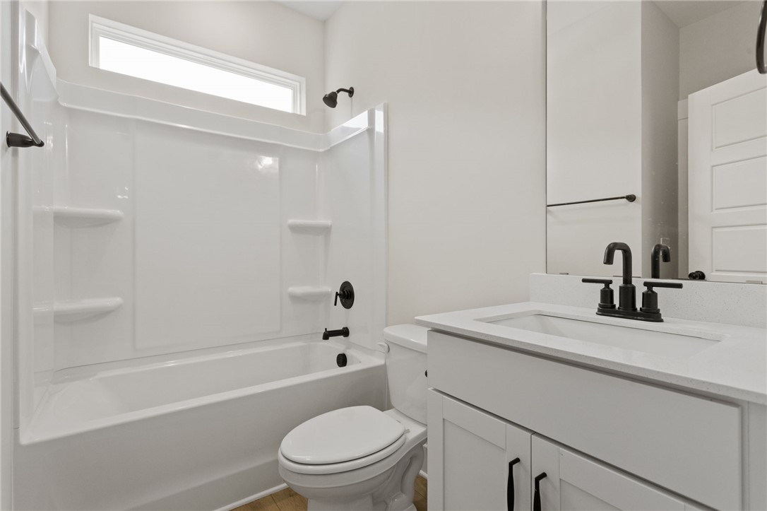 313 Old Shirley Road Central, SC 29630 - Photo 13 of 30 This bright bathroom features a spacious tub and a modern vanity, offering comfort and style.
