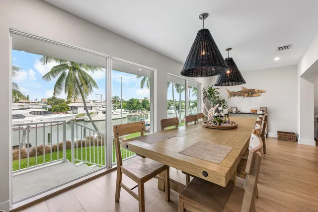 a dining room with furniture a chandelier and wooden floor