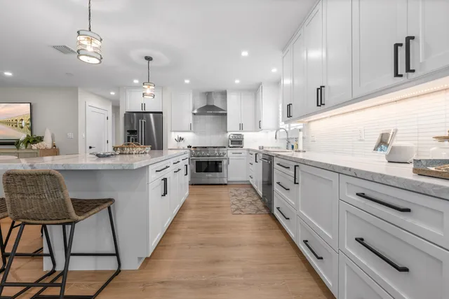 a living room with furniture and a view of kitchen