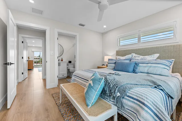 a bedroom with a bed a table and chair