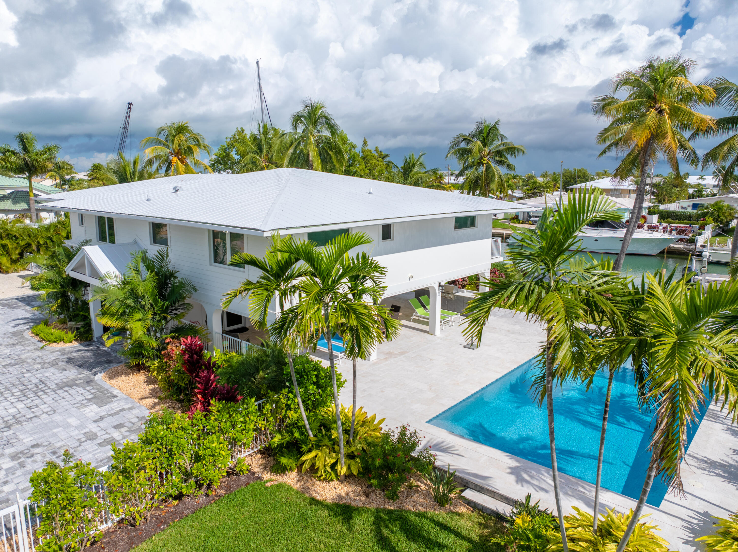 360 12th Street Key Colony Beach, FL 33051 - Photo 3 of 60 a view of a yard with plants and palm trees