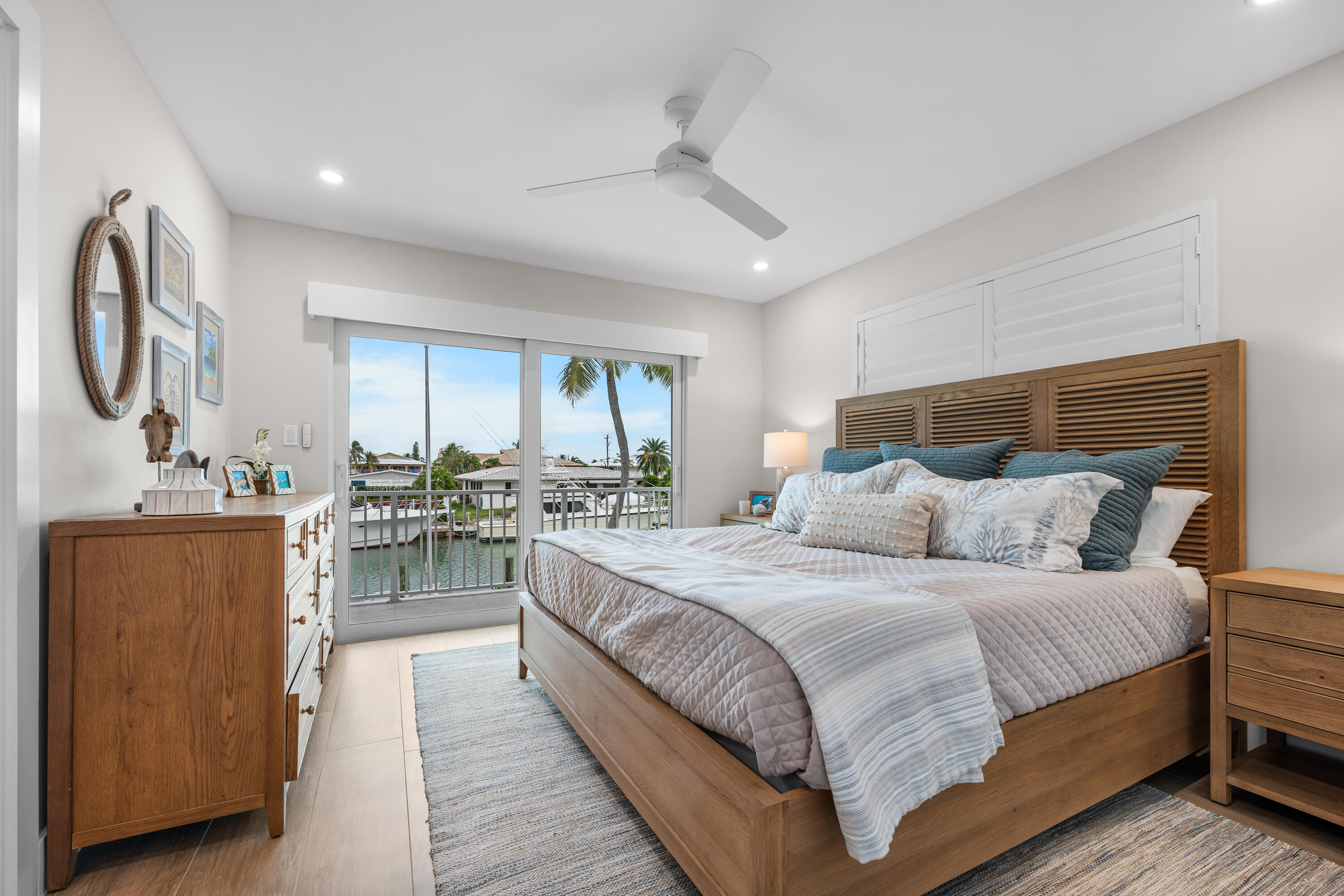 360 12th Street Key Colony Beach, FL 33051 - Photo 31 of 60 a large bedroom with a large bed and a chandelier