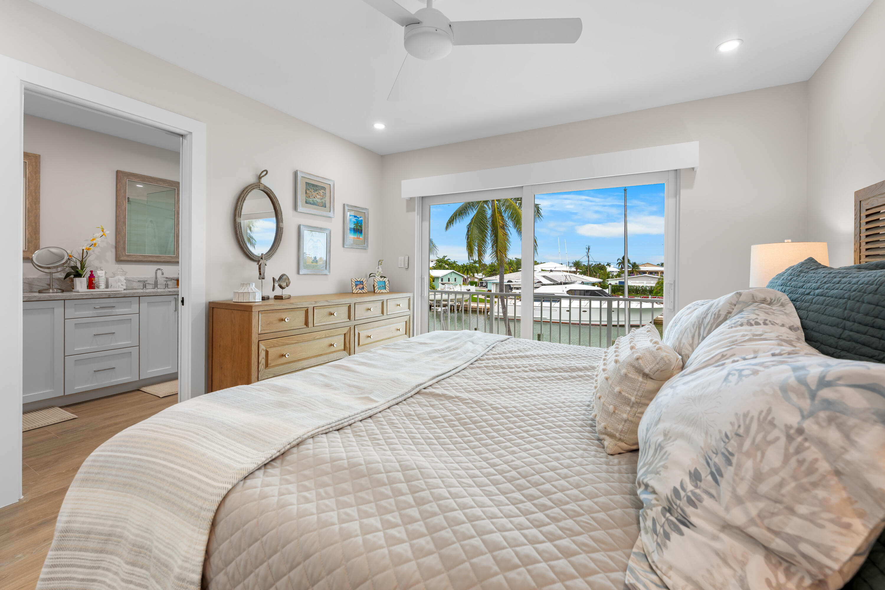 360 12th Street Key Colony Beach, FL 33051 - Photo 35 of 60 a bedroom with a bed a table and chair