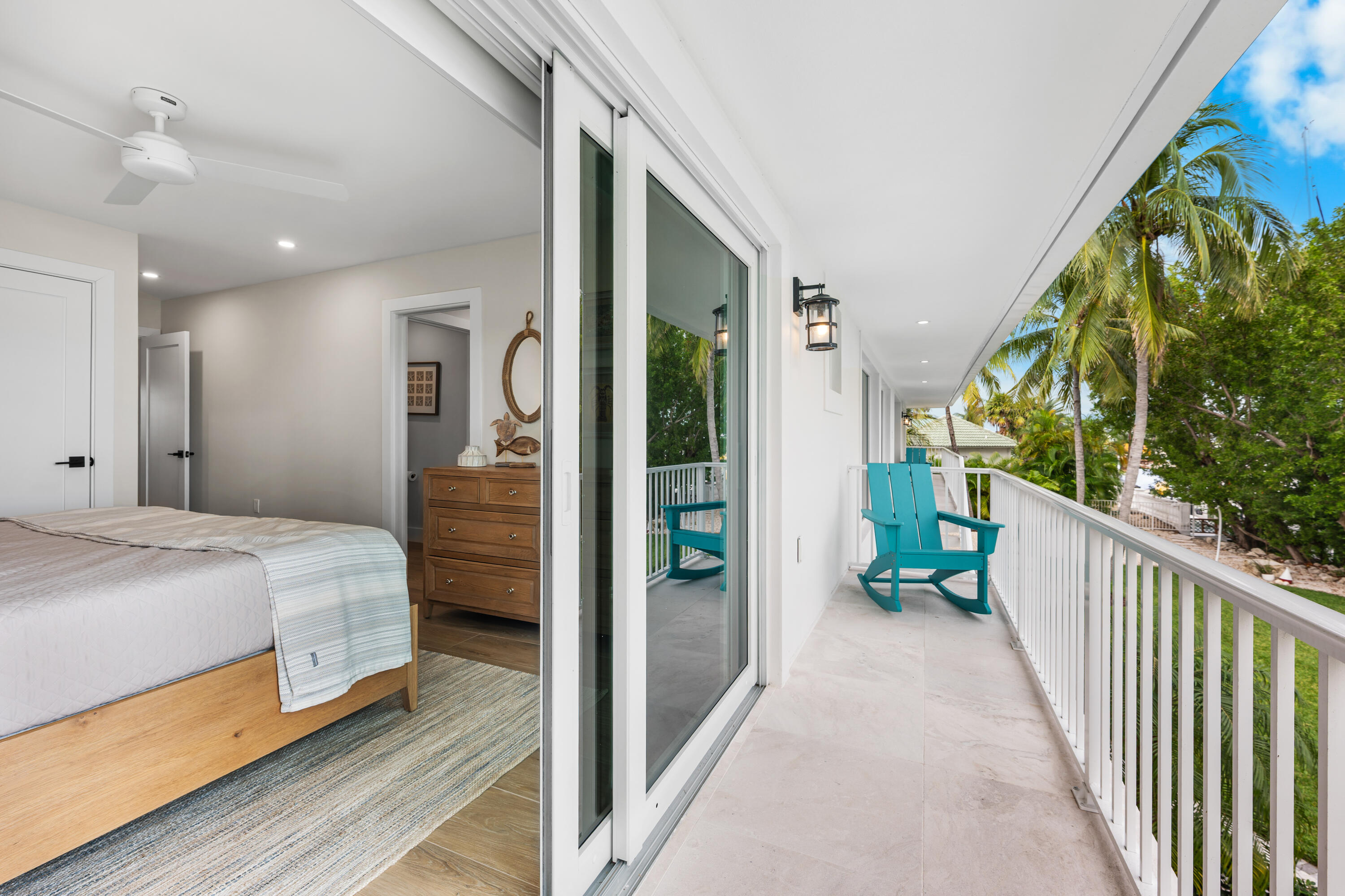 360 12th Street Key Colony Beach, FL 33051 - Photo 36 of 60 a view of a hallway to a livingroom with wooden floor and stairs