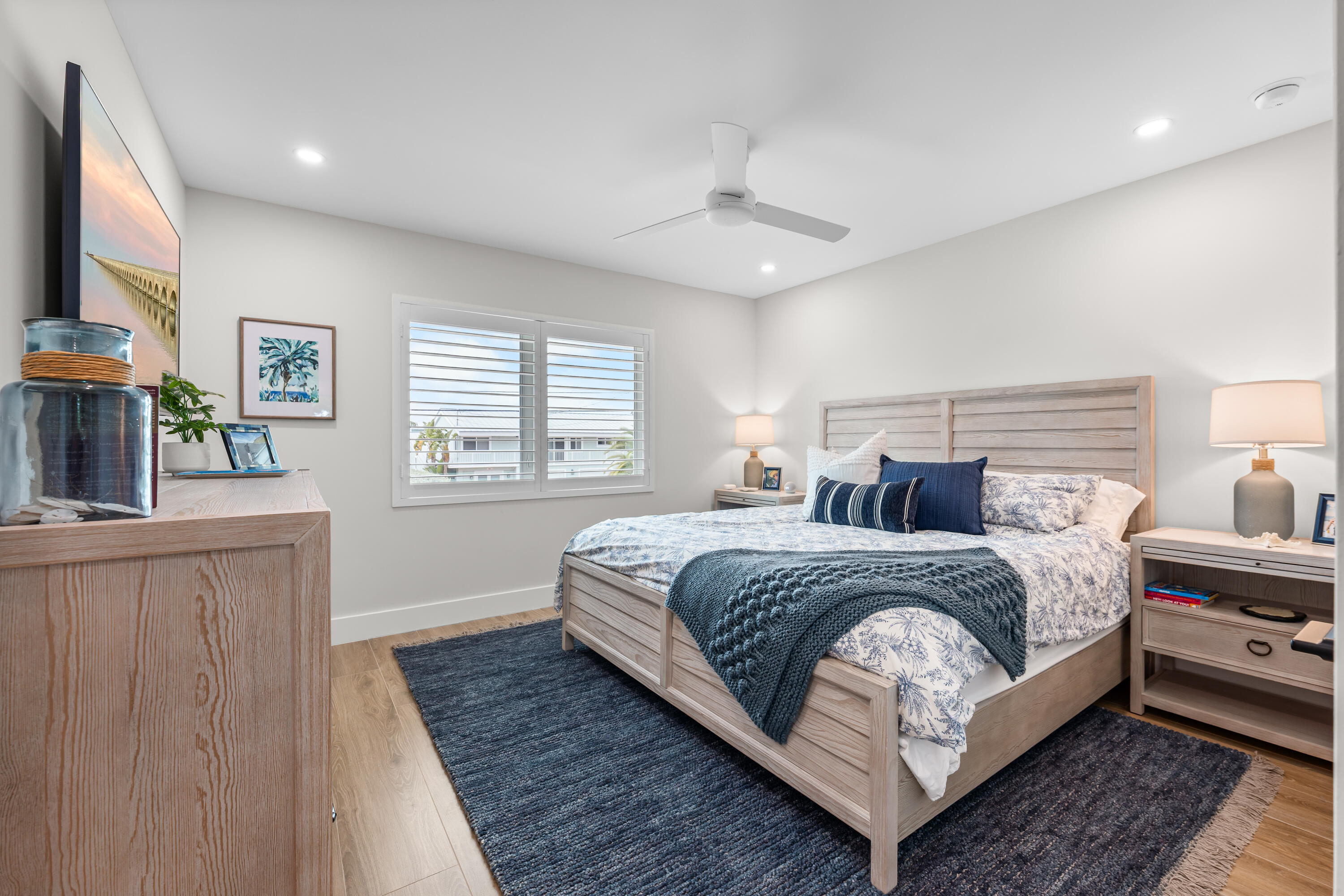 360 12th Street Key Colony Beach, FL 33051 - Photo 42 of 60 a bedroom with a bed a mirror and a window