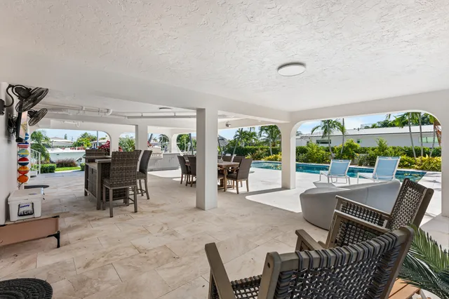 a view of swimming pool with outdoor seating and plants
