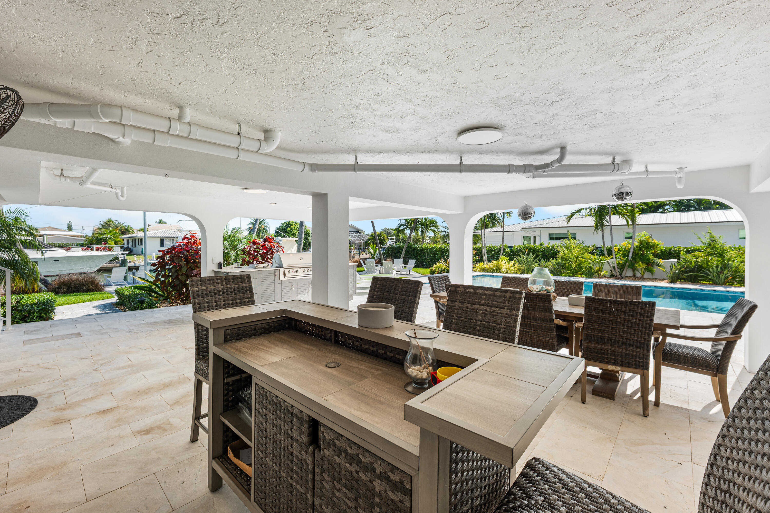 360 12th Street Key Colony Beach, FL 33051 - Photo 48 of 60 a view of a patio with table and chairs potted plants