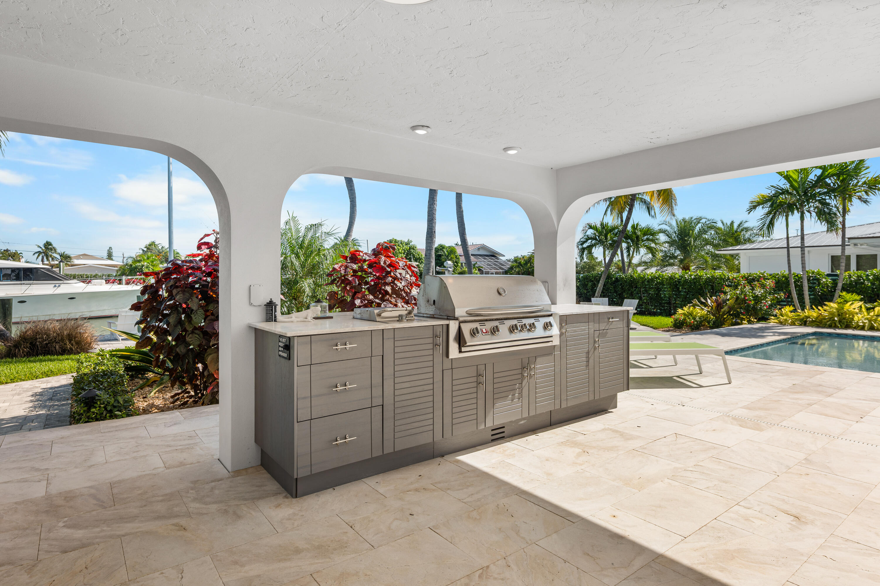 360 12th Street Key Colony Beach, FL 33051 - Photo 49 of 60 a kitchen with stainless steel appliances kitchen island granite countertop a stove a sink and a white cabinets