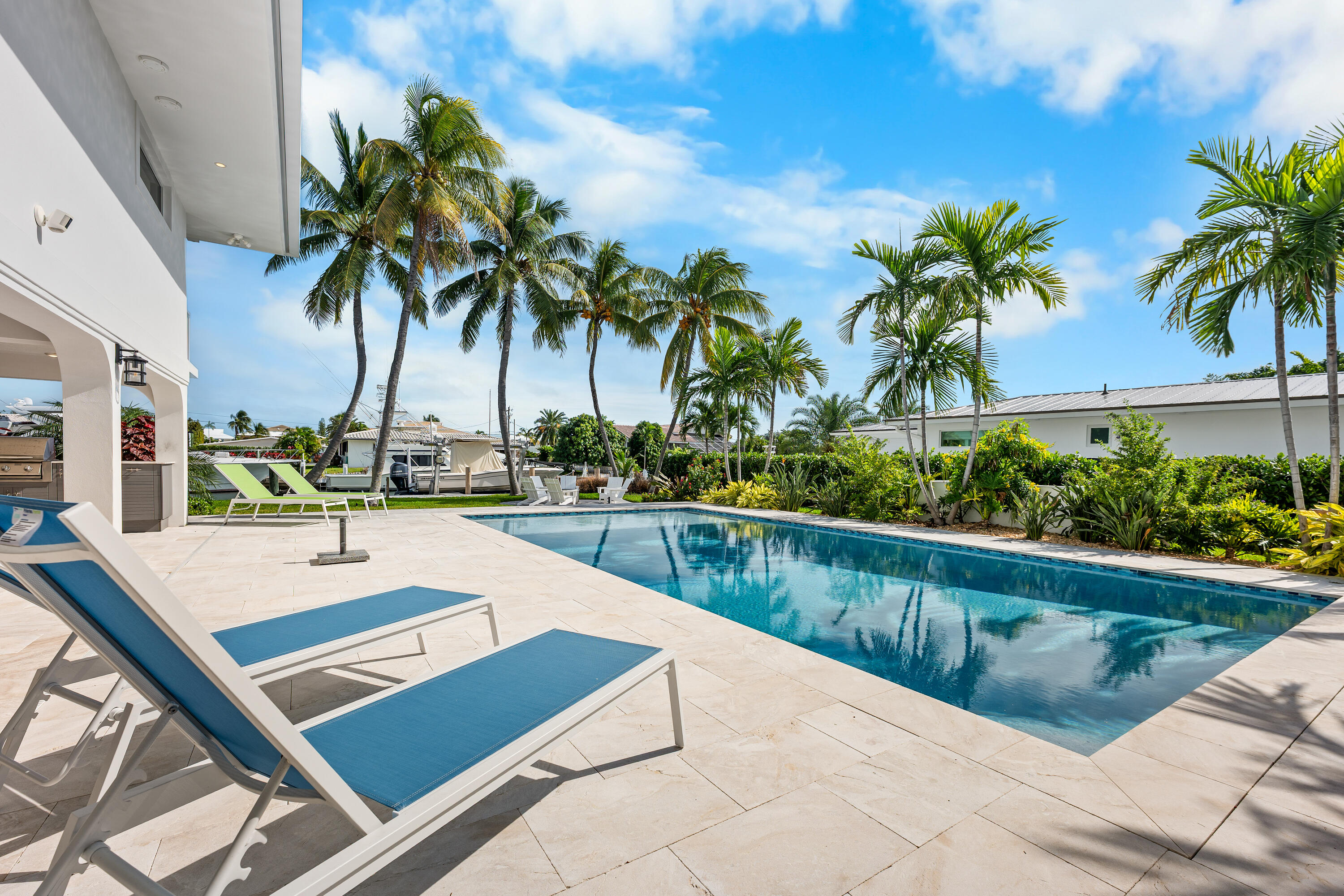 360 12th Street Key Colony Beach, FL 33051 - Photo 53 of 60 a view of swimming pool with outdoor seating and house in the background