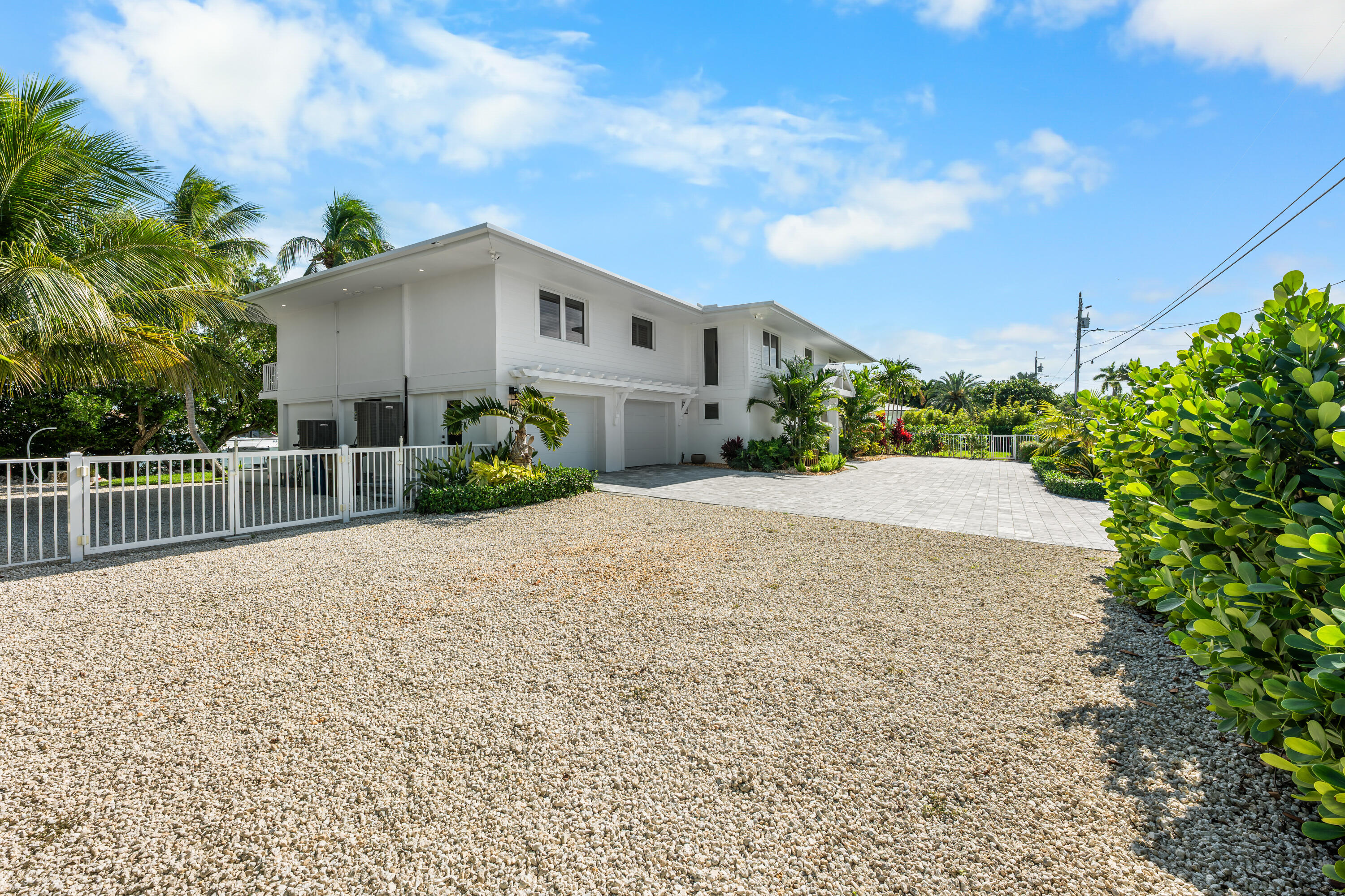 360 12th Street Key Colony Beach, FL 33051 - Photo 60 of 60 a front view of a house with a yard and garage