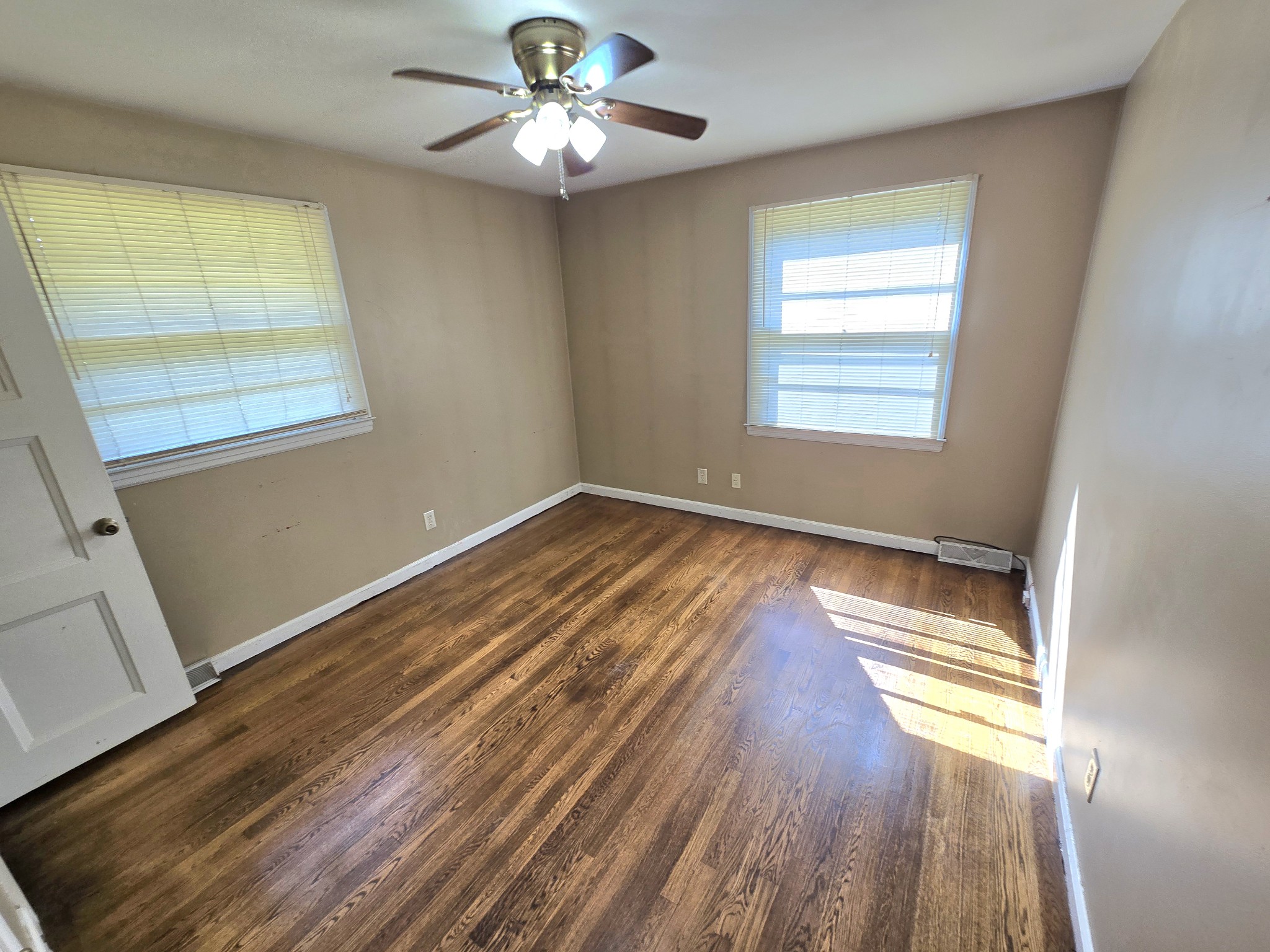 213 Jackson Heights Road Columbia, TN 38401 - Photo 11 of 19 a view of an empty room with wooden floor and a window