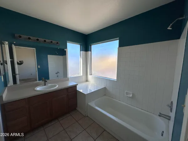 a bathroom with a granite countertop sink a toilet and bathtub