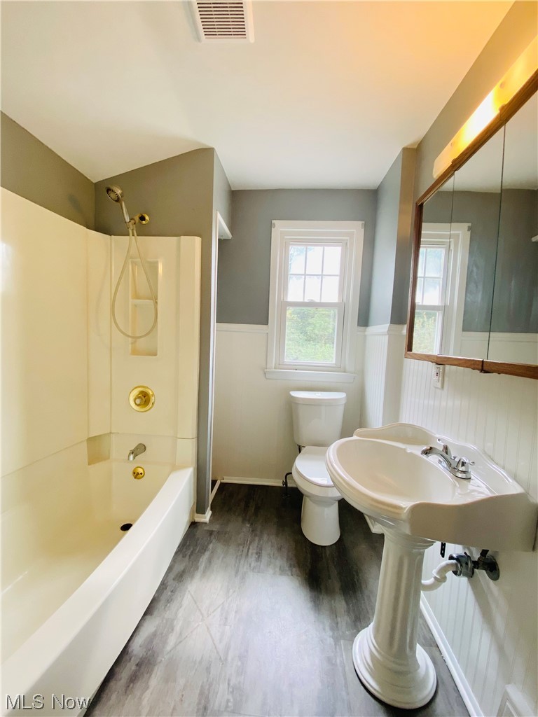 3683 Highland Road Cleveland, OH 44111 - Photo 14 of 17 Full bathroom featuring sink, wood-type flooring, shower / washtub combination, and toilet