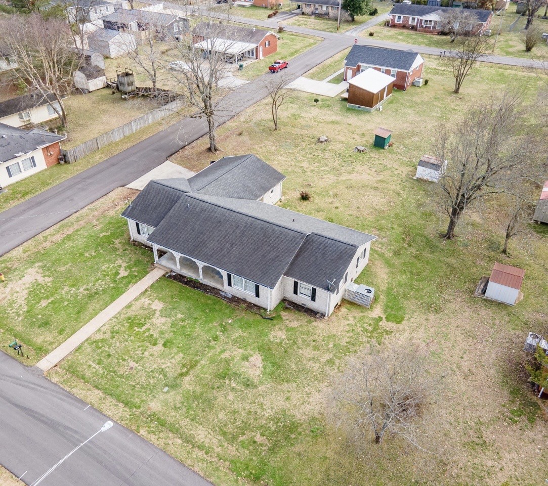 803 Nichols Street Pulaski, TN 38478 - Photo 3 of 8 a backyard of a house with a yard and lake view