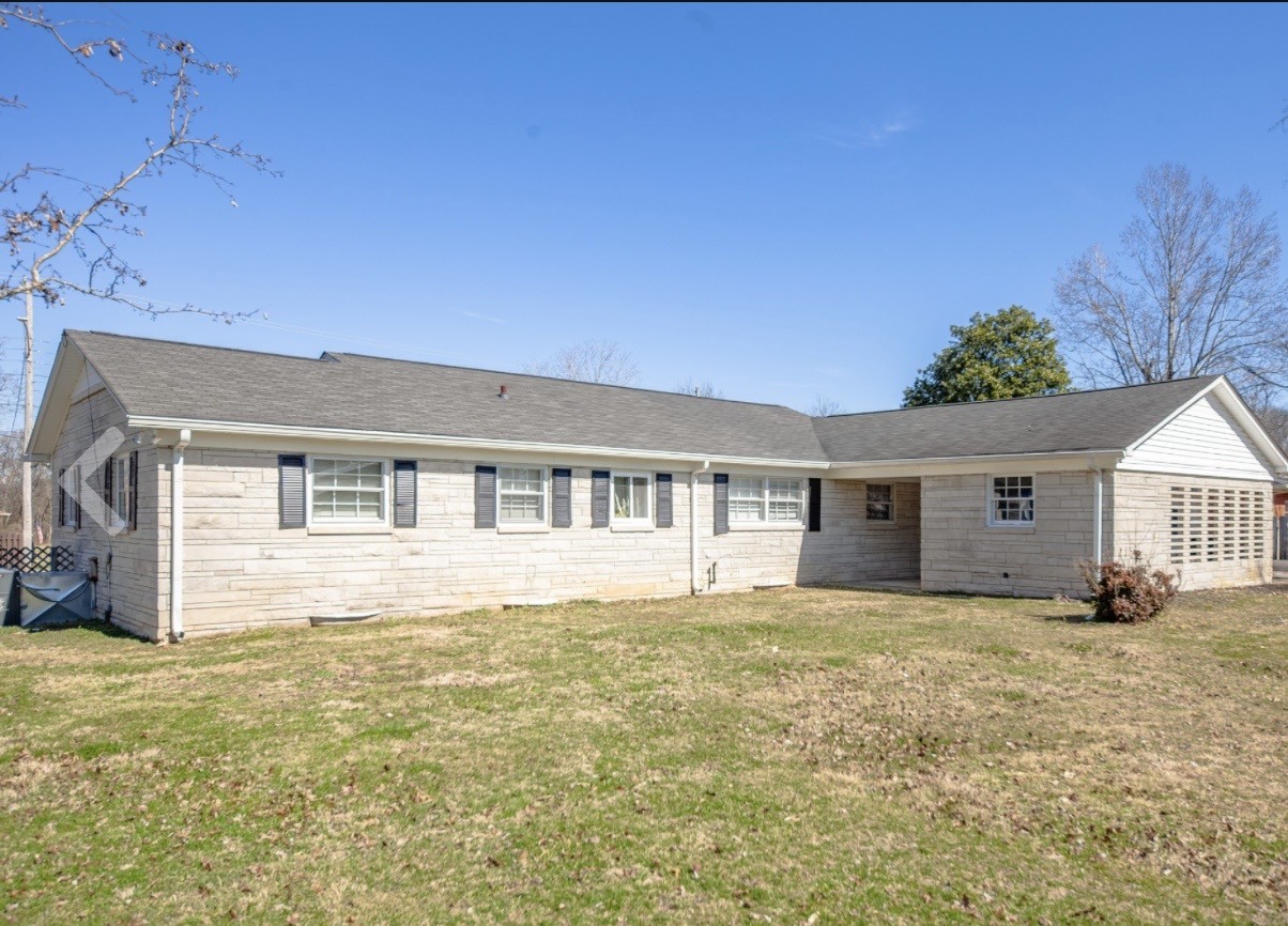 803 Nichols Street Pulaski, TN 38478 - Photo 5 of 8 a house that has a big yard with large trees