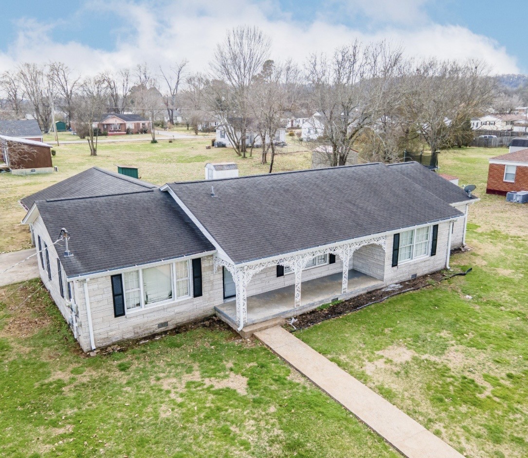 803 Nichols Street Pulaski, TN 38478 - Photo 7 of 8 a view of a house with a big yard and large trees