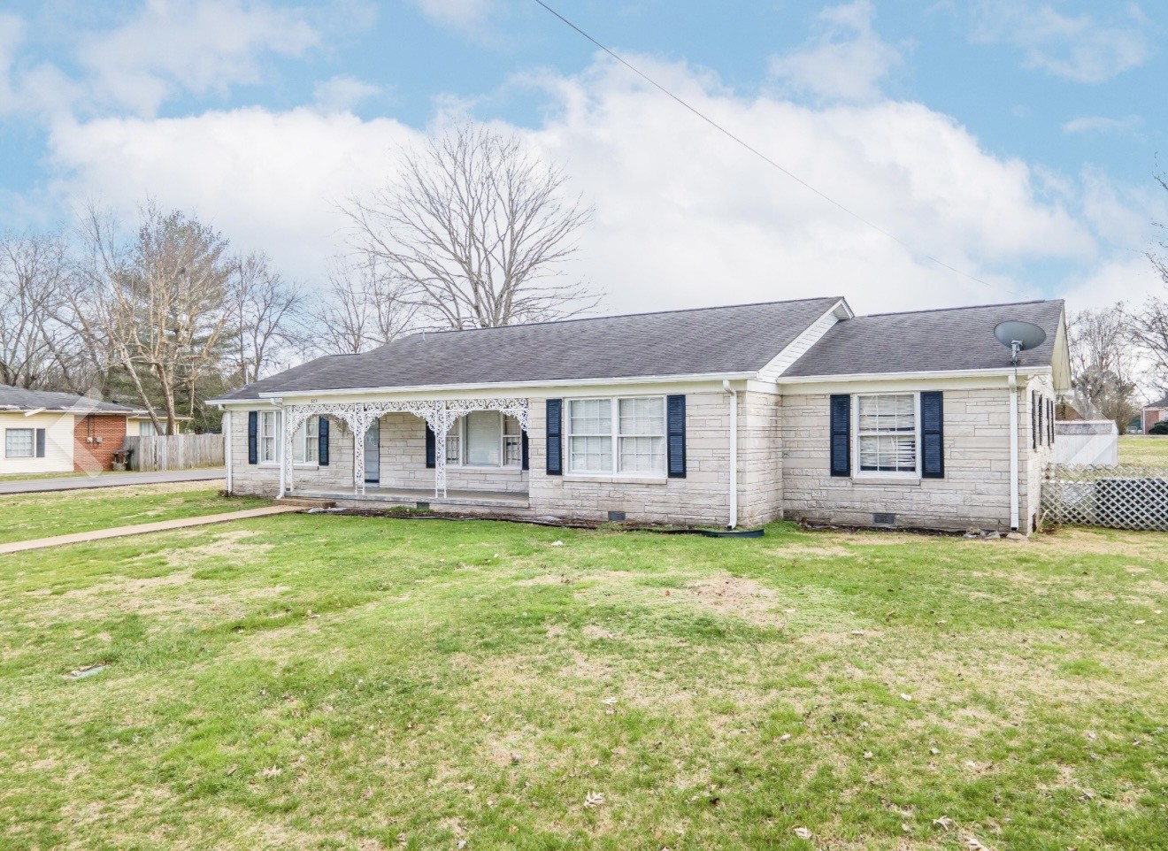 803 Nichols Street Pulaski, TN 38478 - Photo 8 of 8 a front view of a house with a garden and trees