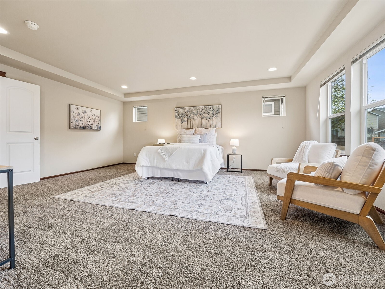 9432 202nd Street East Graham, WA 98338 - Photo 17 of 35 a spacious bedroom with a bed and a couch