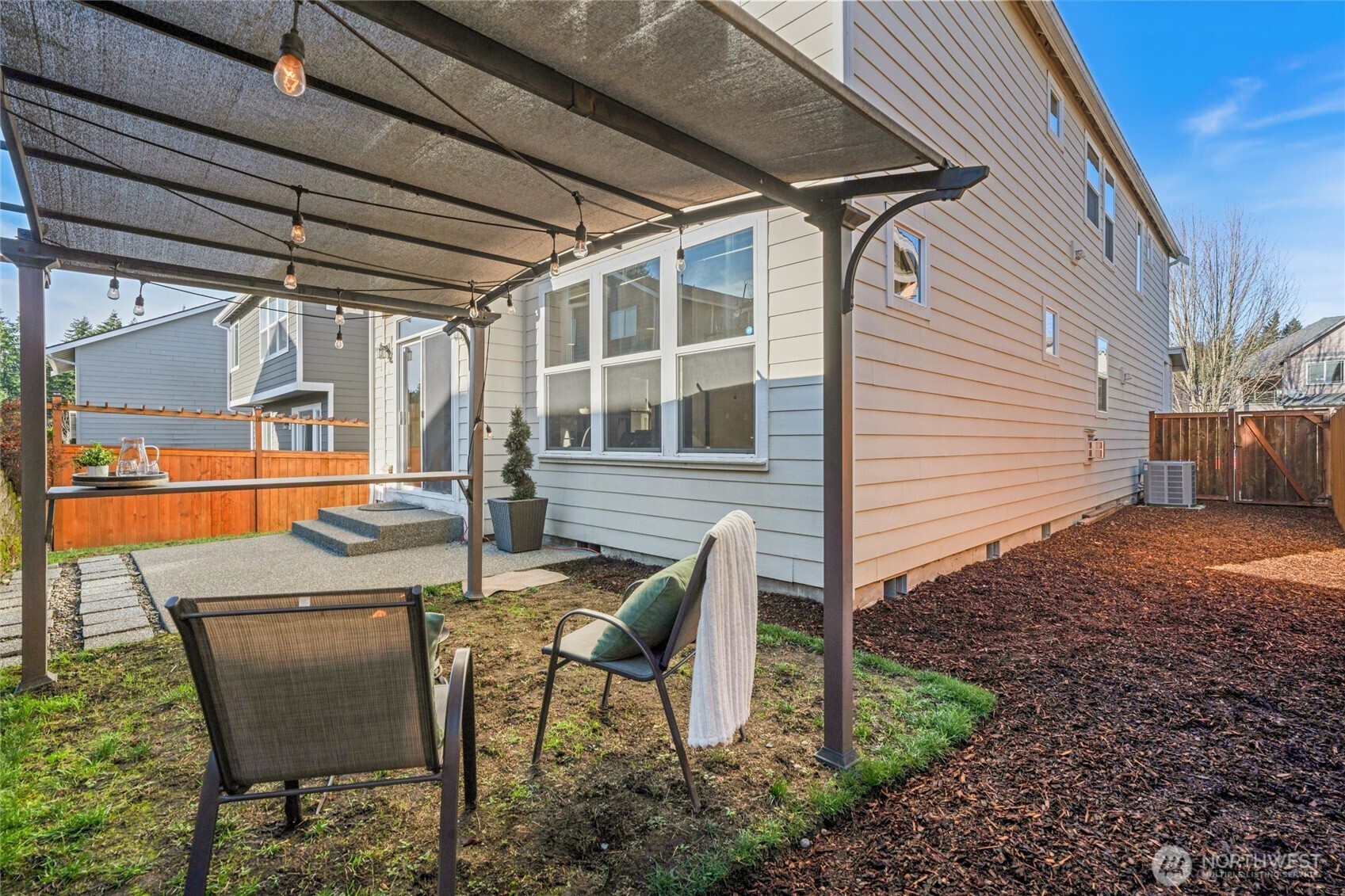 9432 202nd Street East Graham, WA 98338 - Photo 26 of 35 a view of a patio with table and chairs and wooden floor