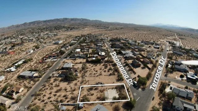 an aerial view of residential houses with outdoor space
