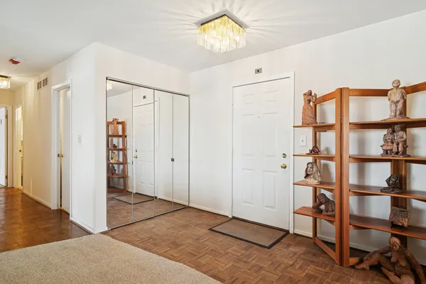 a view of a bedroom with cabinets and wooden floor