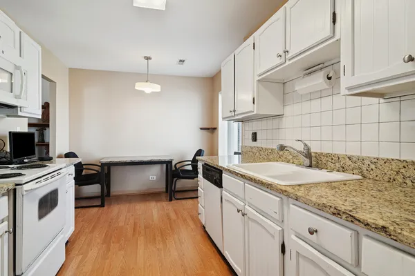 a kitchen with a sink stove and cabinets