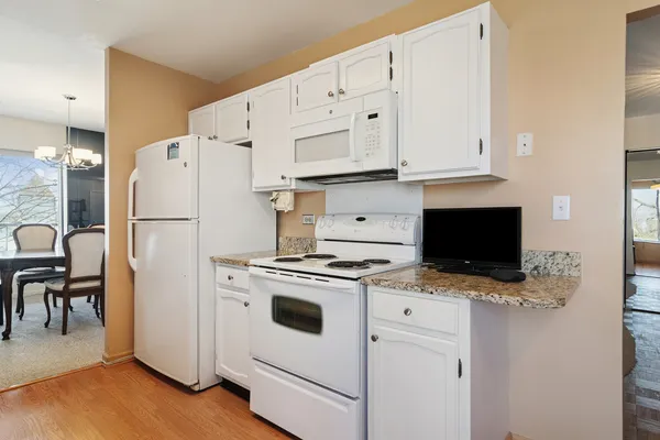 a white refrigerator freezer sitting in a kitchen