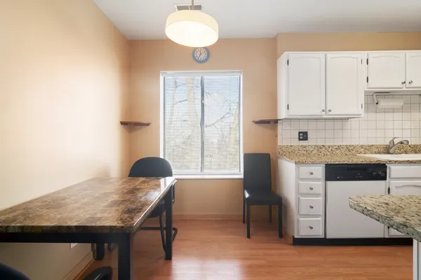 a kitchen with stainless steel appliances granite countertop a stove top oven a sink counter space and cabinets