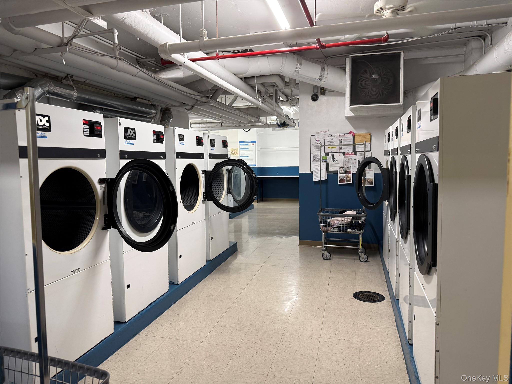 220-55 46th Avenue, Unit 10D Queens, NY 11361 - Photo 22 of 32 Community laundry room featuring washing machine and dryer