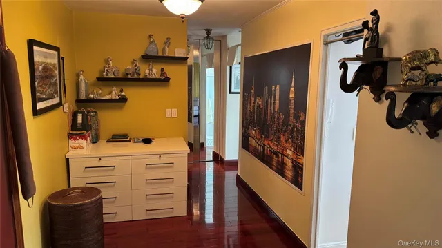 a kitchen with stainless steel appliances kitchen island granite countertop a stove a refrigerator a sink a dining table and chairs with wooden floor