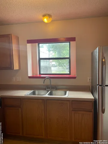 a kitchen with a sink and a window