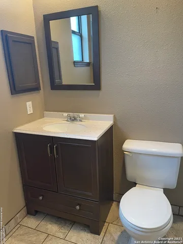 a white toilet sitting next to a bathroom sink
