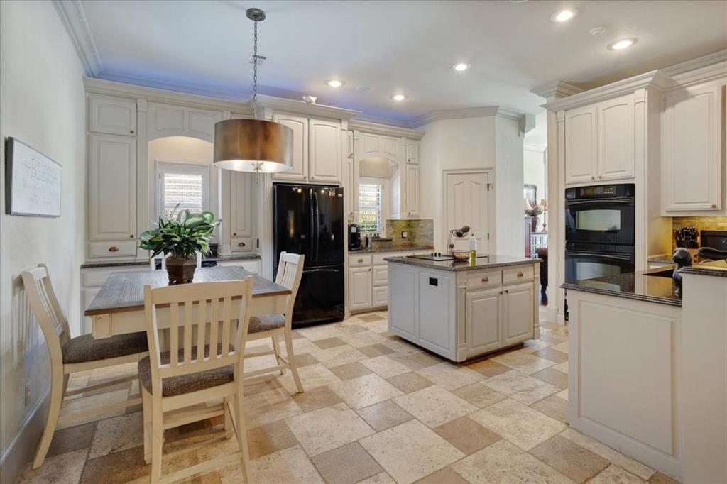 3001 Canyon Creek Drive Sherman, TX 75092 - Photo 12 of 37 a kitchen with stainless steel appliances kitchen island granite countertop a refrigerator and a stove top oven