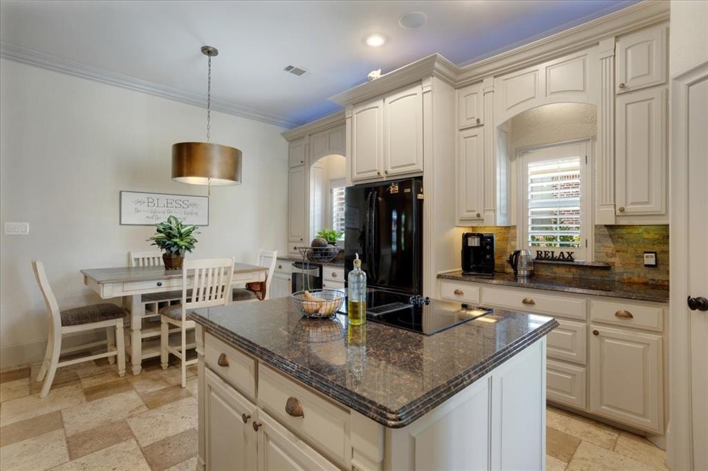 3001 Canyon Creek Drive Sherman, TX 75092 - Photo 14 of 37 a kitchen with kitchen island granite countertop a table and chairs in it