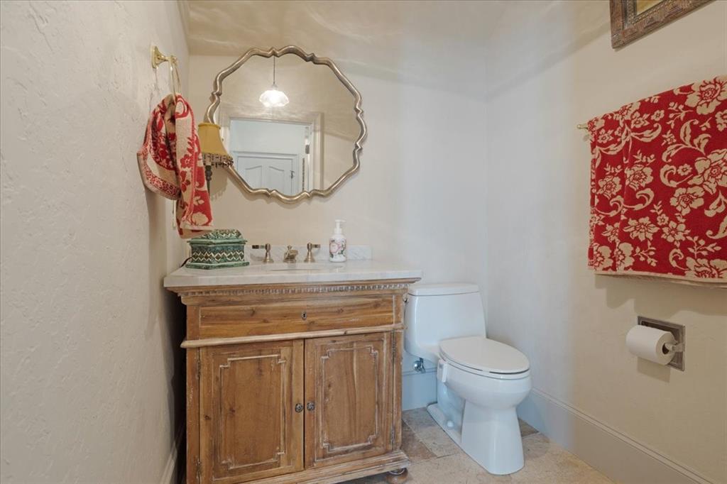 3001 Canyon Creek Drive Sherman, TX 75092 - Photo 32 of 37 a bathroom with a toilet a sink and mirror
