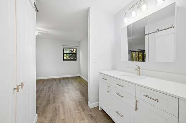 a view of an empty room with wooden floor