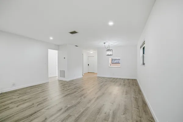 a kitchen with granite countertop a stove a sink and a refrigerator