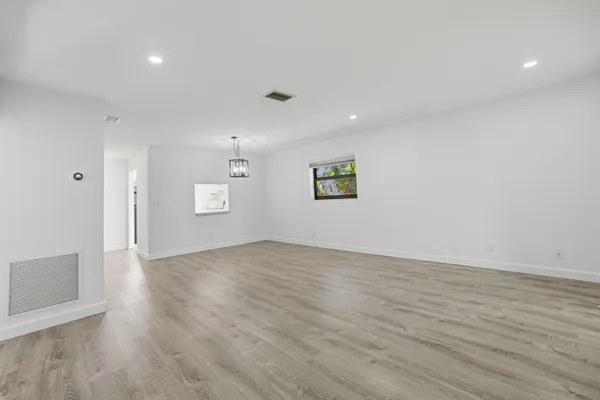 a kitchen with cabinets appliances and a window