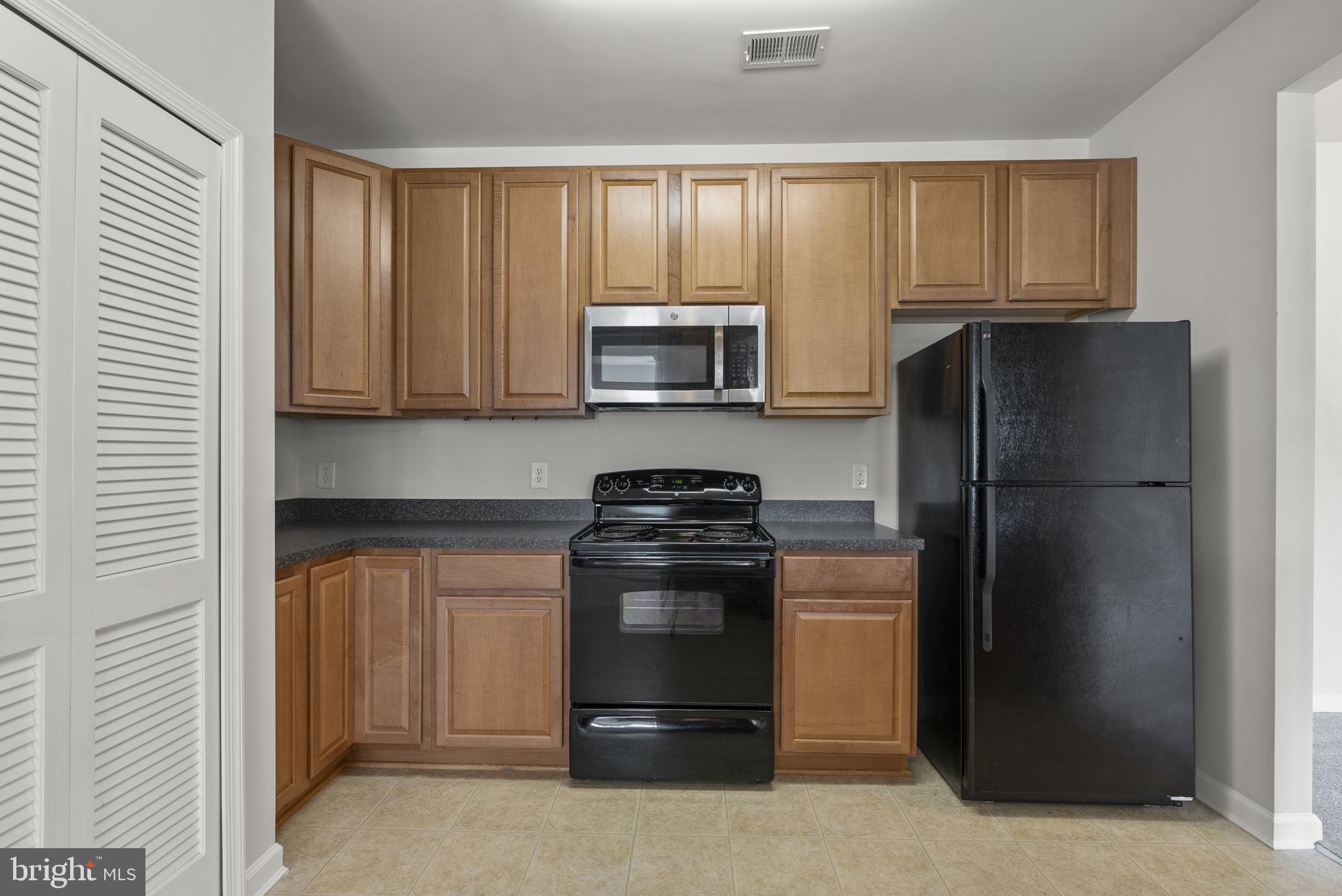 1622 Hardwick Court, Unit 201 Hanover, MD 21076 - Photo 11 of 42 a kitchen with a stove a refrigerator and cabinets