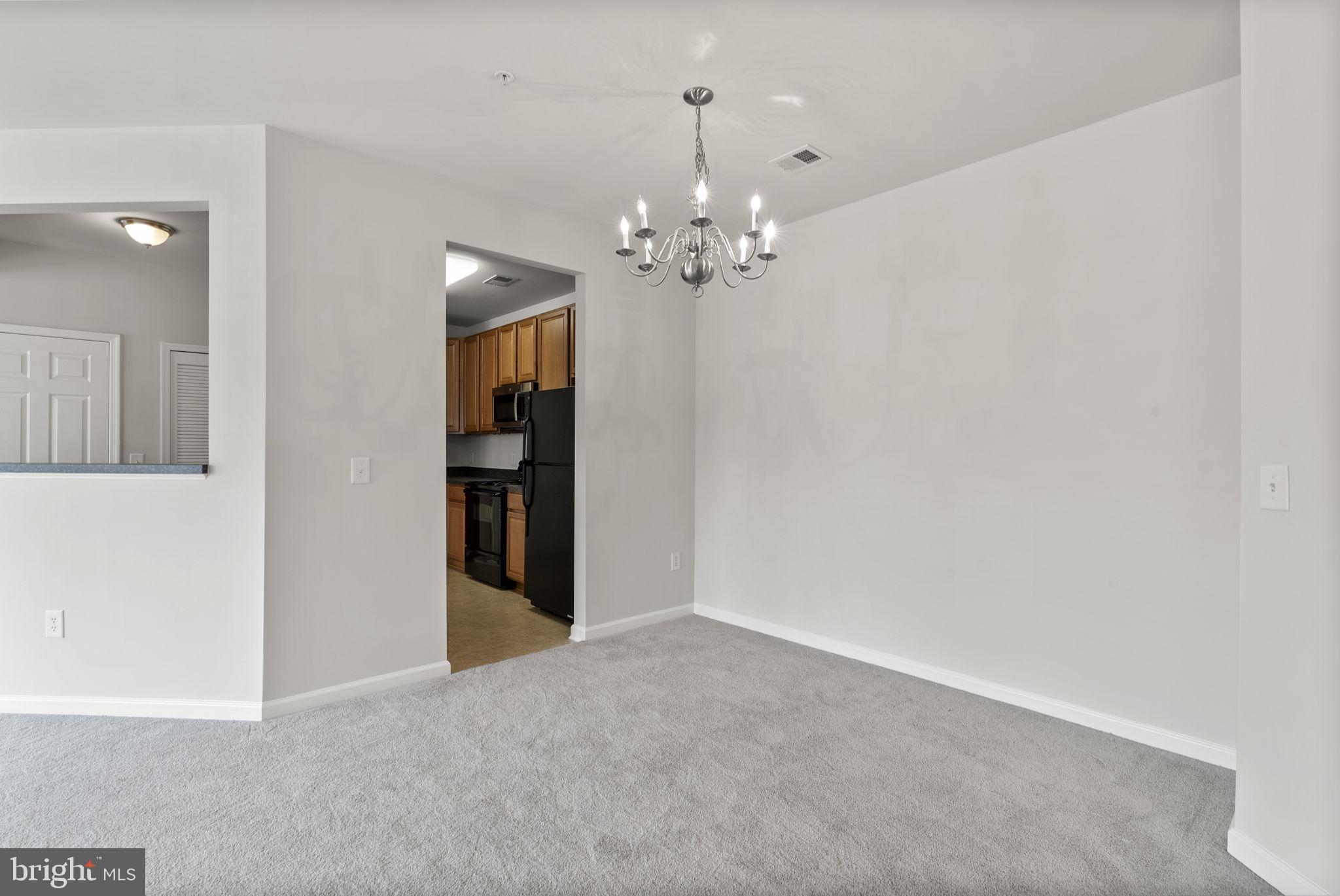 1622 Hardwick Court, Unit 201 Hanover, MD 21076 - Photo 17 of 42 a view of a chandelier in an empty room