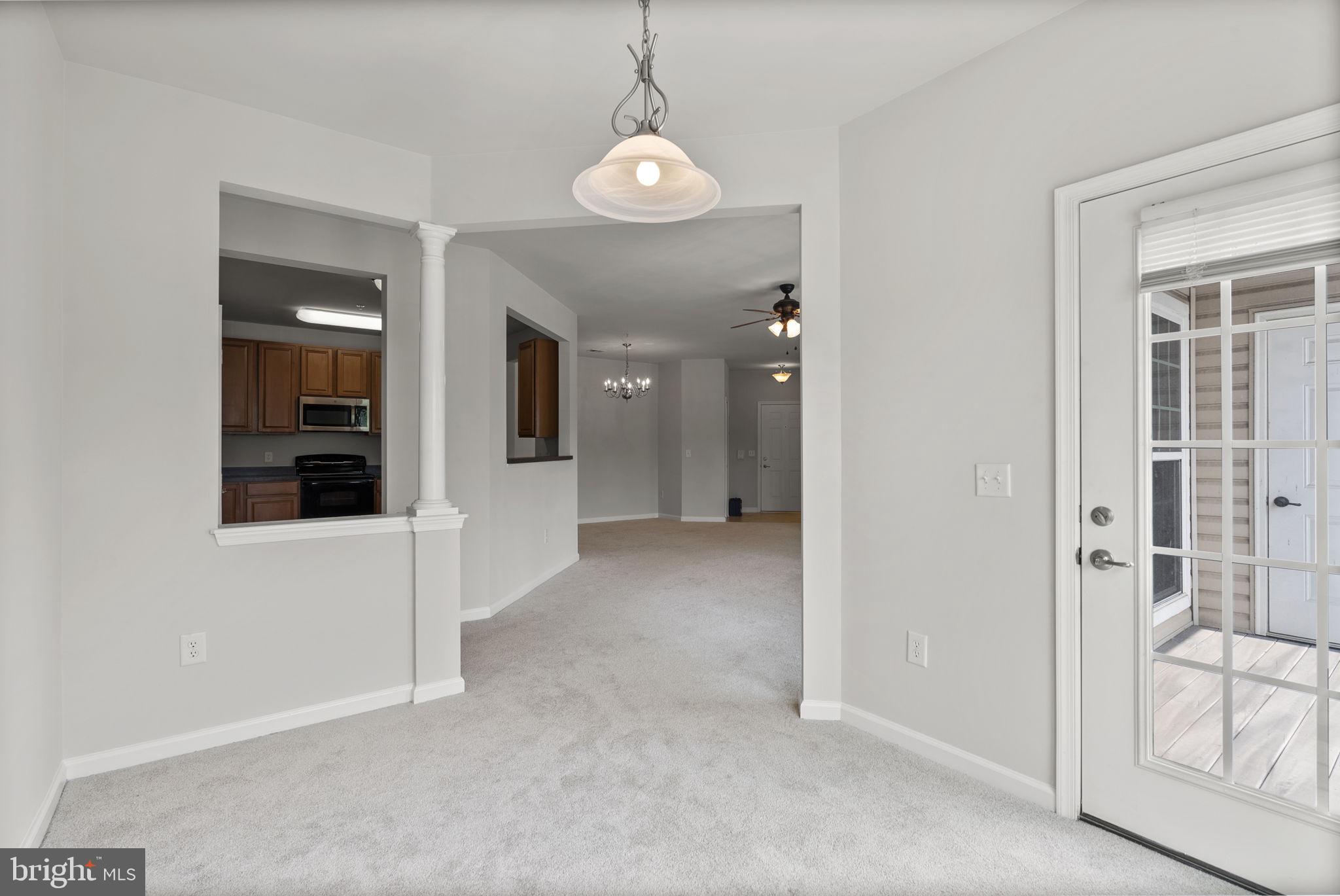 1622 Hardwick Court, Unit 201 Hanover, MD 21076 - Photo 25 of 42 a view of a hallway with wooden floor and glass door